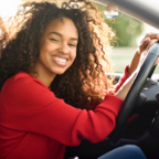 Smiling woman at the wheel of a vehicle