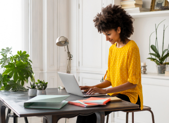 A young women uses her laptop in her home office