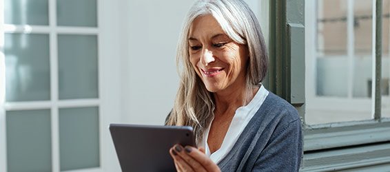 Smiling woman looking at tablet