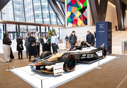 Jaguar Formula E displayed in showroom with viewers