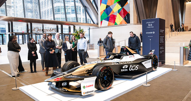 Jaguar Formula E displayed in showroom with viewers