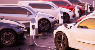 Multiple electric vehicles plugged in at charging stations