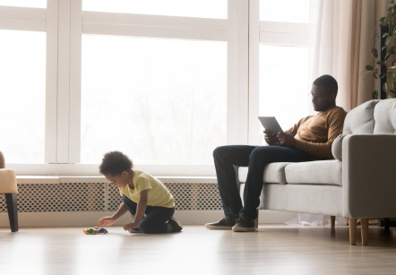 A father and son relaxing in the living room