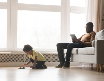 A father and son relaxing in the living room