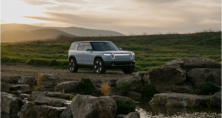 Rivian's latest electric mid-size SUV, the R2, parked in the wilderness