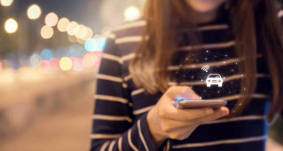 Woman using her smartphone to interact with her car's wireless connected features