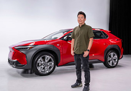 Subaru's Garrick Goh standing in front of a red Subaru Solterra