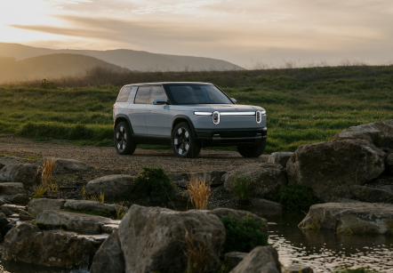 Rivian's latest electric mid-size SUV, the R2, parked in the wilderness