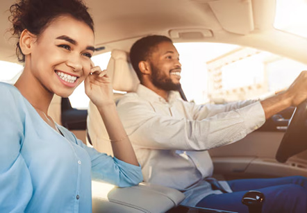 Young couple in a car, travelling together