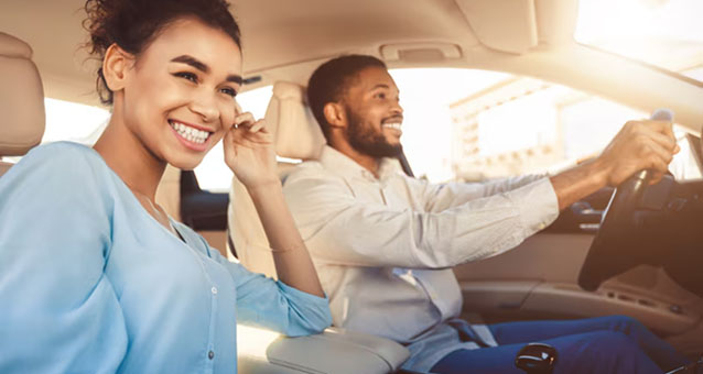 Young couple in a car, travelling together