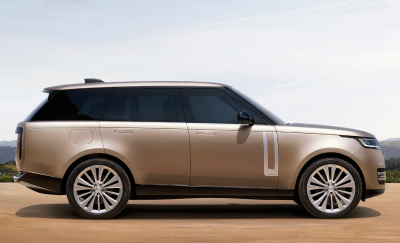 An electric Range Rover parked off a desert road