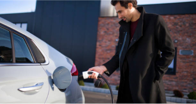 A man charges an electric car