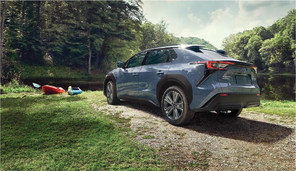 A Subaru Electric Vehicle parked on the banks of a river