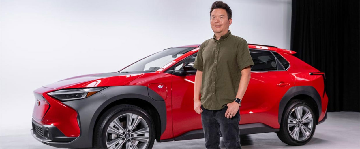 Subaru's Garrick Goh standing in front of a red Subaru Solterra