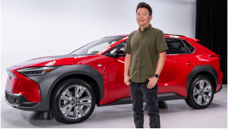 Subaru's Garrick Goh standing in front of a red Subaru Solterra